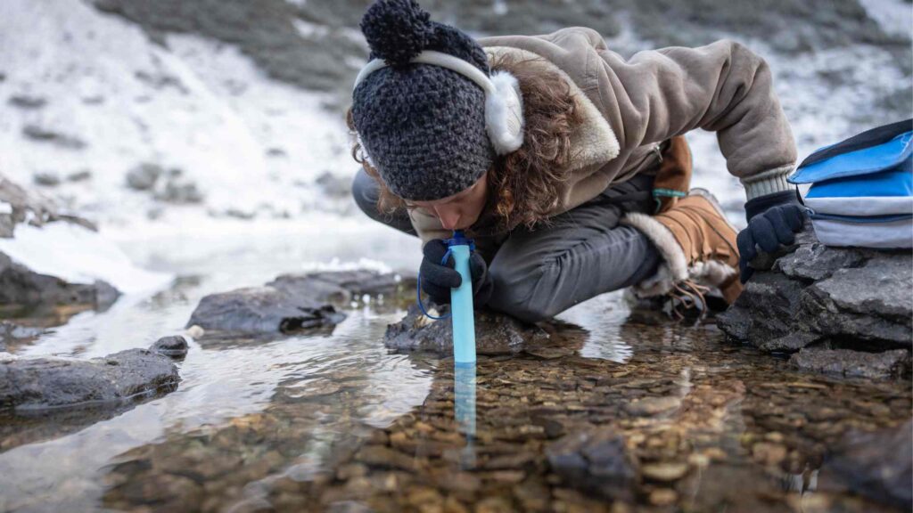 Woman drinking through water filtration straw